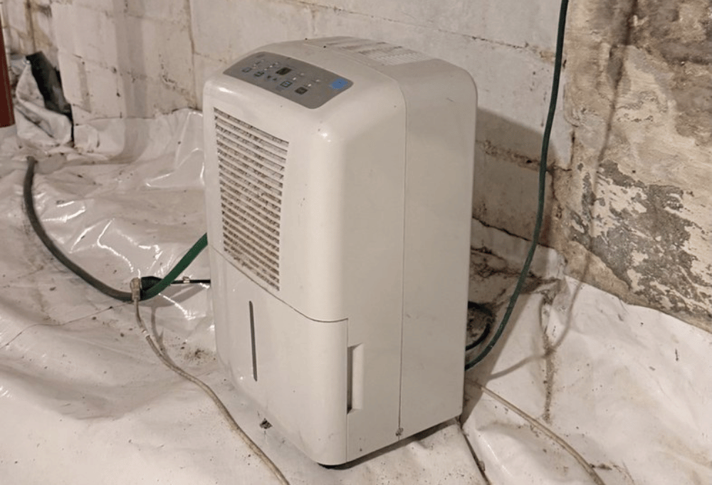Dehumidifier near moisture affected foundation walls in a Newburyport MA basement
